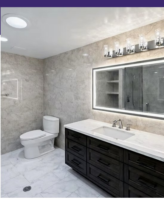 Finished bathroom remodel with dark vanity and tiled shower
